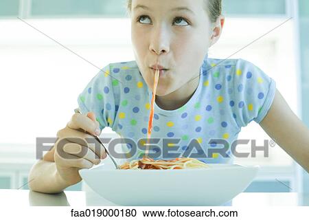 Girl slurping spaghetti noodles View Large Photo Image Stock Image - Girl slurping spaghetti noodles. Fotosearch