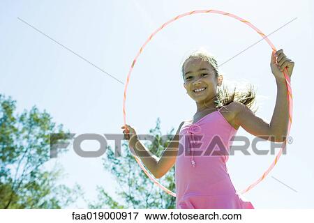 Stock Photo - Girl with hoola hoop. Fotosearch