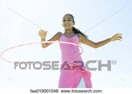 Girl with hoola hoop View Large Photo Image Stock Photo - Girl with hoola hoop. Fotosearch