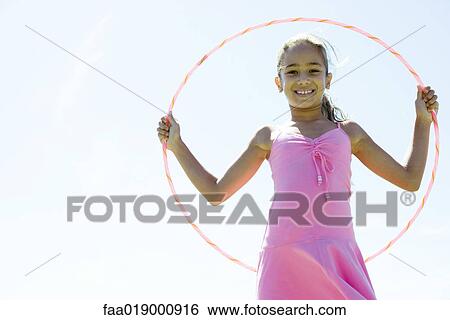 Stock Photograph - Girl with hoola hoop. Fotosearch