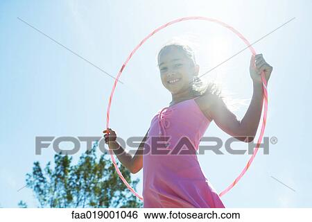 Girl with hoola hoop View Large Photo Image Stock Photograph - Girl with hoola hoop. Fotosearch