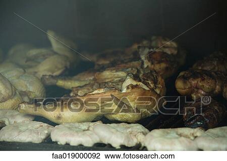 Stock Image - Grilling meats. Fotosearch