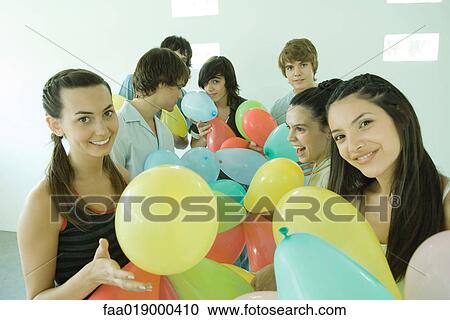 Group of young friends with balloons View Large Photo Image Stock Image - Group of young friends with balloons. Fotosearch