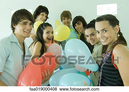 Group of young friends with balloons View Large Photo Image Stock Photo - Group of young friends with balloons. Fotosearch