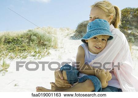 Little boy with mother on beach View Large Photo Image Stock Image - Little boy with mother on beach. Fotosearch
