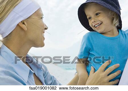 Little girl with mother on beach View Large Photo Image Stock Image - Little girl with mother on beach. Fotosearch