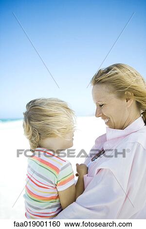 Little girl with mother on beach View Large Photo Image Stock Image - Little girl with mother on beach. Fotosearch