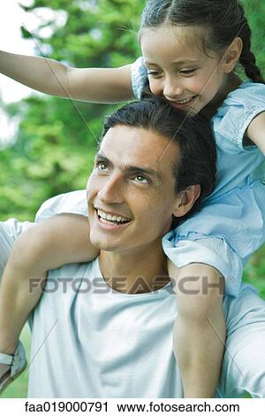 Man carrying daughter on his shoulders View Large Photo Image Stock Image - Man carrying daughter on his shoulders. Fotosearch