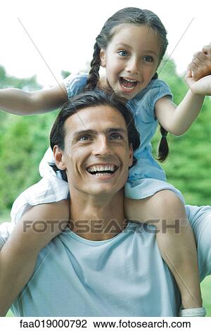 Man carrying daughter on his shoulders View Large Photo Image Stock Image - Man carrying daughter on his shoulders. Fotosearch