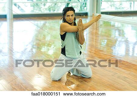 Stock Image - Man doing arm stretches. Fotosearch