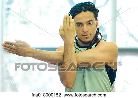 Man doing arm stretches View Large Photo Image Stock Image - Man doing arm stretches. Fotosearch