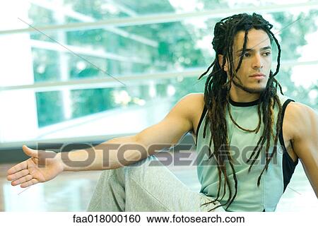 Stock Image - Man doing side stretch. Fotosearch