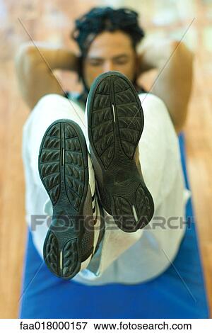 Stock Photo - Man doing sit-ups. Fotosearch