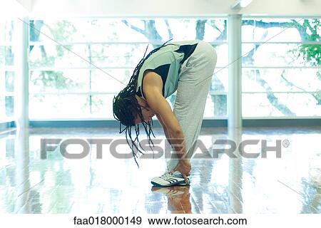 Man doing standing forward bend, full length, side view View Large Photo Image Stock Photo - Man doing standing forward bend, full length, side view. Fotosearch