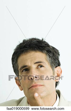 Man, finger on chin, looking up, portrait View Large Photo Image Stock Photo - Man, finger on chin, looking up, portrait. Fotosearch
