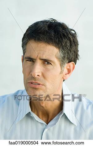 Man, furrowing brow, portrait View Large Photo Image Picture - Man, furrowing brow, portrait. Fotosearch