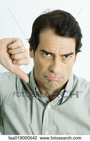Man giving thumbs down sign, portrait View Large Photo Image Stock Image - Man giving thumbs down sign, portrait. Fotosearch