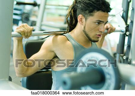 Picture - Man lifting barbell. Fotosearch