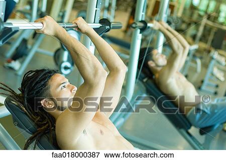 Man lifting barbell, reflected in mirror View Large Photo Image Stock Photo - Man lifting barbell, reflected in mirror. Fotosearch