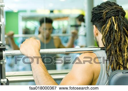 Man lifting barbell View Large Photo Image Stock Photo - Man lifting barbell. Fotosearch