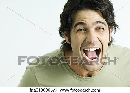 Stock Photo - Man, mouth wide open and eyebrows raised, portrait. Fotosearch