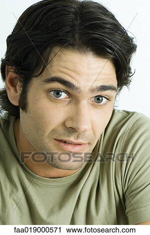 Man raising eyebrows, looking down, portrait View Large Photo Image Stock Image - Man raising eyebrows, looking down, portrait. Fotosearch