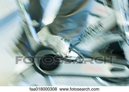 Man riding exercise bike, close-up of feet, blurred motion View Large Photo Image Stock Photo - Man riding exercise bike, close-up of feet, blurred motion. Fotosearch