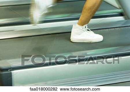 Man running on treadmill, close-up of feet View Large Photo Image Stock Image - Man running on treadmill, close-up of feet. Fotosearch