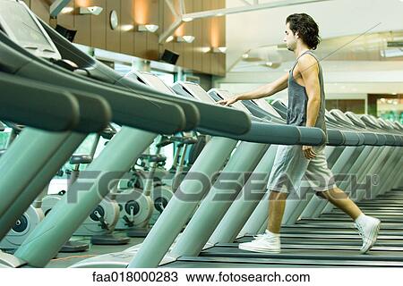 Man running on treadmill View Large Photo Image Stock Image - Man running on treadmill. Fotosearch