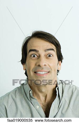 Man, smiling, eyes wide open, portrait View Large Photo Image Stock Photography - Man, smiling, eyes wide open, portrait. Fotosearch