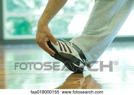 Man touching toe, close-up View Large Photo Image Stock Photography - Man touching toe, close-up. Fotosearch