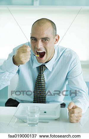 Man using fork to eat vitamins from plate View Large Photo Image Stock Photo - Man using fork to eat vitamins from plate. Fotosearch