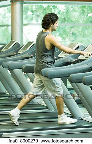 Man walking on treadmill View Large Photo Image Stock Photo - Man walking on treadmill. Fotosearch