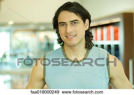 Man wearing sleeveless tee-shirt, smiling, portrait View Large Photo Image Stock Photo - Man wearing sleeveless tee-shirt, smiling, portrait. Fotosearch