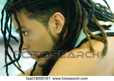Stock Image - Man with dreadlocks, close-up, profile. Fotosearch