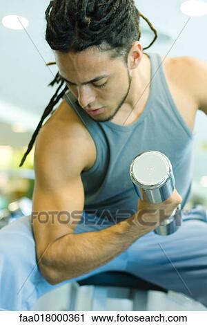 Man working biceps with dumbbell View Large Photo Image Stock Image - Man working biceps with dumbbell. Fotosearch