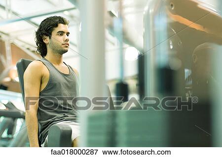 Man working out on weight machine View Large Photo Image Stock Photo - Man working out on weight machine. Fotosearch