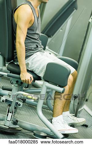 Man working out on weight machine View Large Photo Image Stock Photography - Man working out on weight machine. Fotosearch