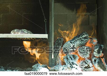 Meat grilling in wood oven View Large Photo Image Stock Photo - Meat grilling in wood oven. Fotosearch