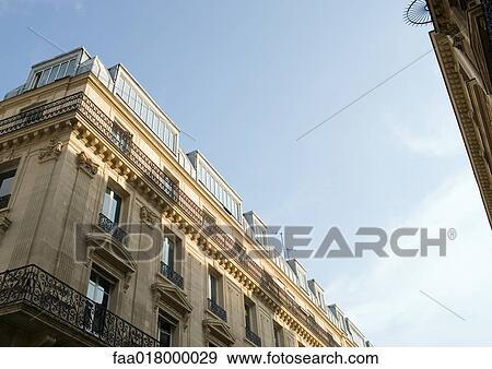 Stock Photo - Paris, France, apartment building, low angle view. Fotosearch