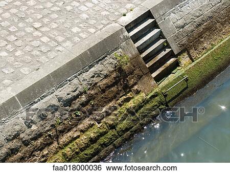 Steps on quay leading to river, high angle view View Large Photo Image Stock Photograph - Steps on quay leading to river, high angle view. Fotosearch