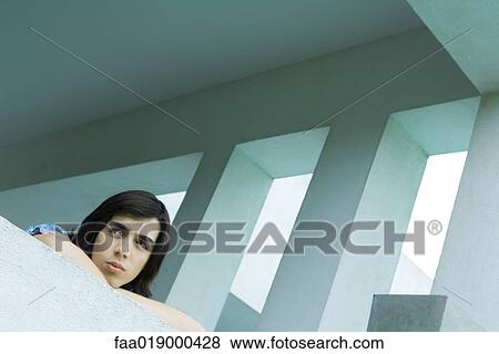Stock Photo - Teen boy leaning on balcony. Fotosearch