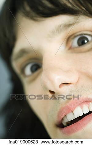 Teen boy leering at camera, extreme close-up View Large Photo Image Stock Photo - Teen boy leering at camera, extreme close-up. Fotosearch