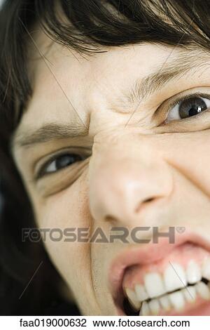Teen boy making angry face, extreme close-up View Large Photo Image Stock Image - Teen boy making angry face, extreme close-up. Fotosearch
