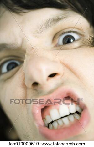 Teen boy making angry face, extreme close-up View Large Photo Image Stock Photo - Teen boy making angry face, extreme close-up. Fotosearch