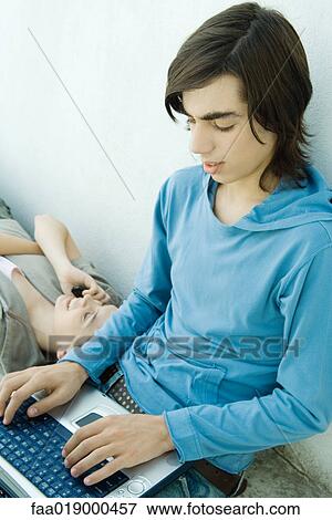 Teen boy using laptop View Large Photo Image Stock Photo - Teen boy using laptop. Fotosearch