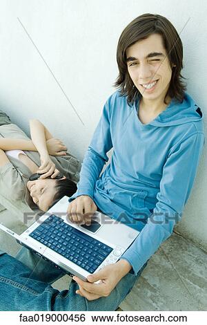 Stock Photograph - Teen boy using laptop. Fotosearch
