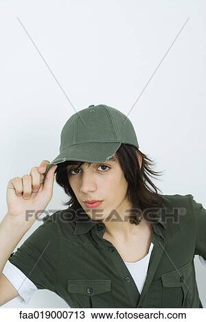 Stock Image - Teen boy wearing cap, portrait. Fotosearch
