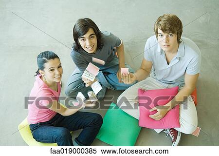 Teen friends playing cards, one throwing cards into the air View Large Photo Image Stock Photography - Teen friends playing cards, one throwing cards into the air. Fotosearch