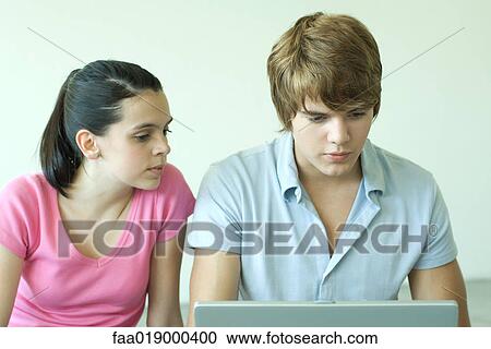 Teen friends using laptop together View Large Photo Image Stock Image - Teen friends using laptop together. Fotosearch